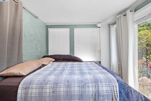 a bedroom with a bed and a window