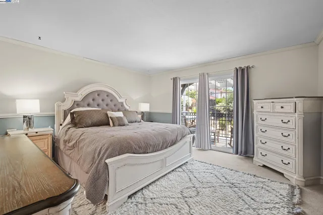 a spacious bedroom with a bed and a large window