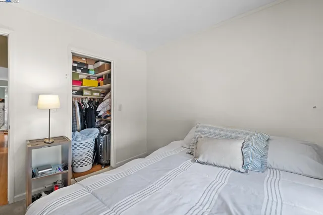 a bedroom with a bed and a chair