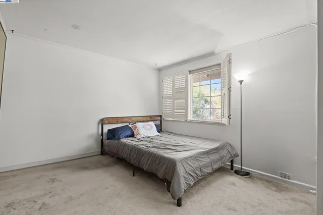 a bedroom with a bed and window