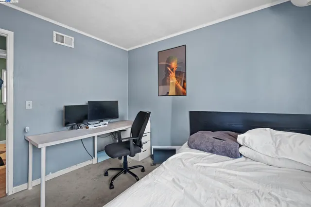 a bedroom with a workspace