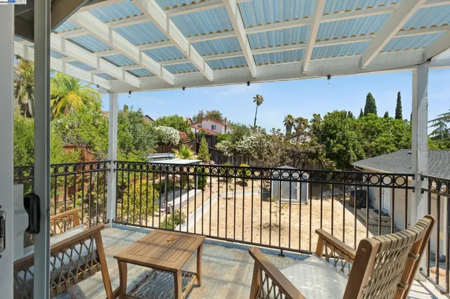 a view of a balcony with furniture