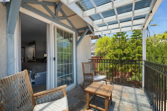 a balcony with furniture and a potted plant