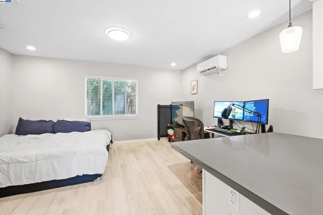 a spacious bedroom with a bed a table and chairs