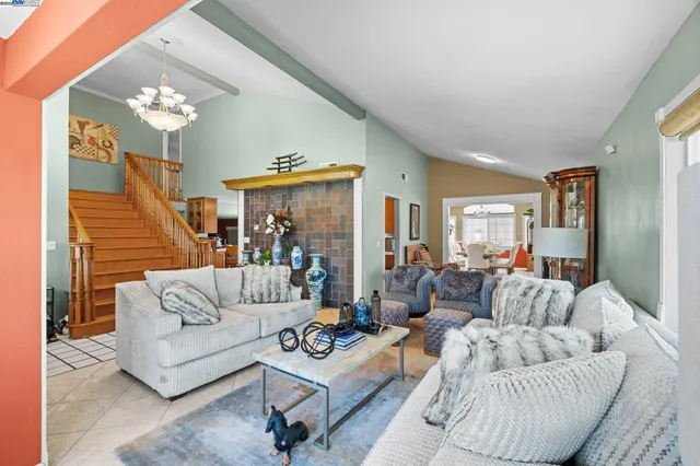 a living room with furniture and a large mirror or wooden floor