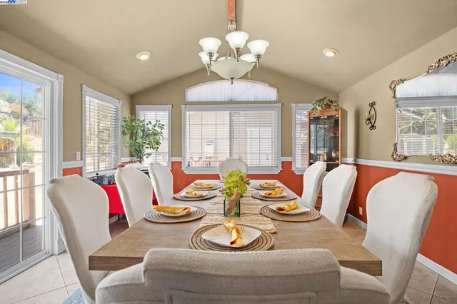a living room with dining table furniture and a chandelier