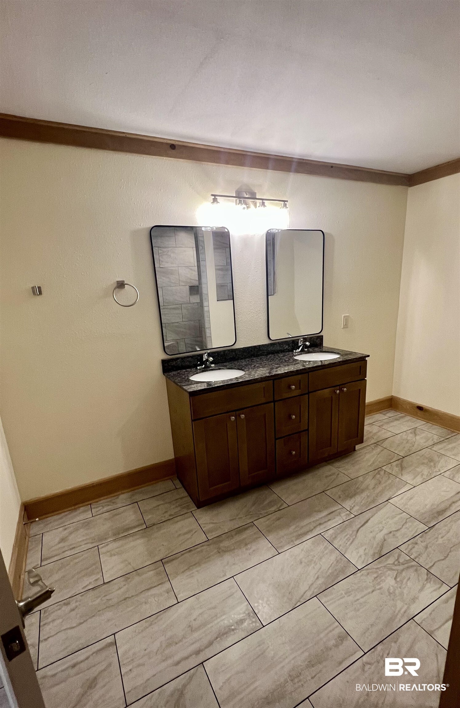 29685 Gardner Road Elberta, AL 36530 - Photo 13 of 16 Dual vanity with dark wood cabinetry, granite-style countertop, and rectangular undermount sinks
