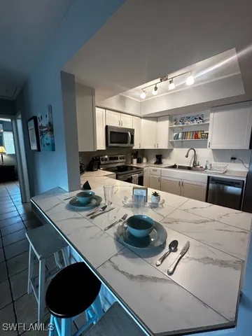 a kitchen with a stove a microwave a dining table and chairs