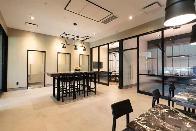 a view of a a dining room with furniture window and wooden floor