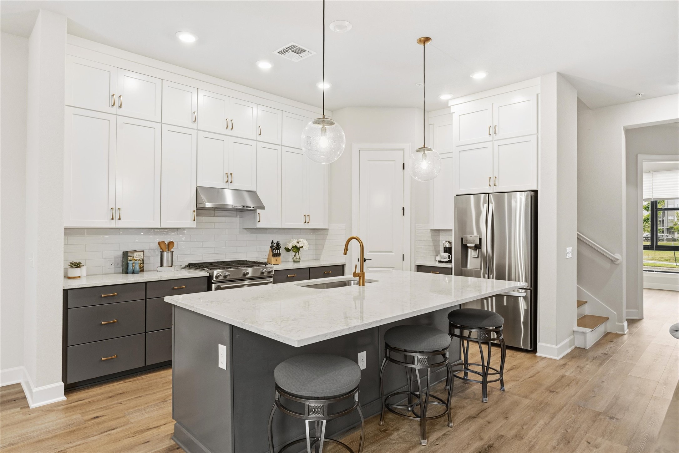 4704 Eberly Street Austin, TX 78723 - Photo 13 of 39 a kitchen with stainless steel appliances granite countertop a table chairs sink refrigerator and cabinets