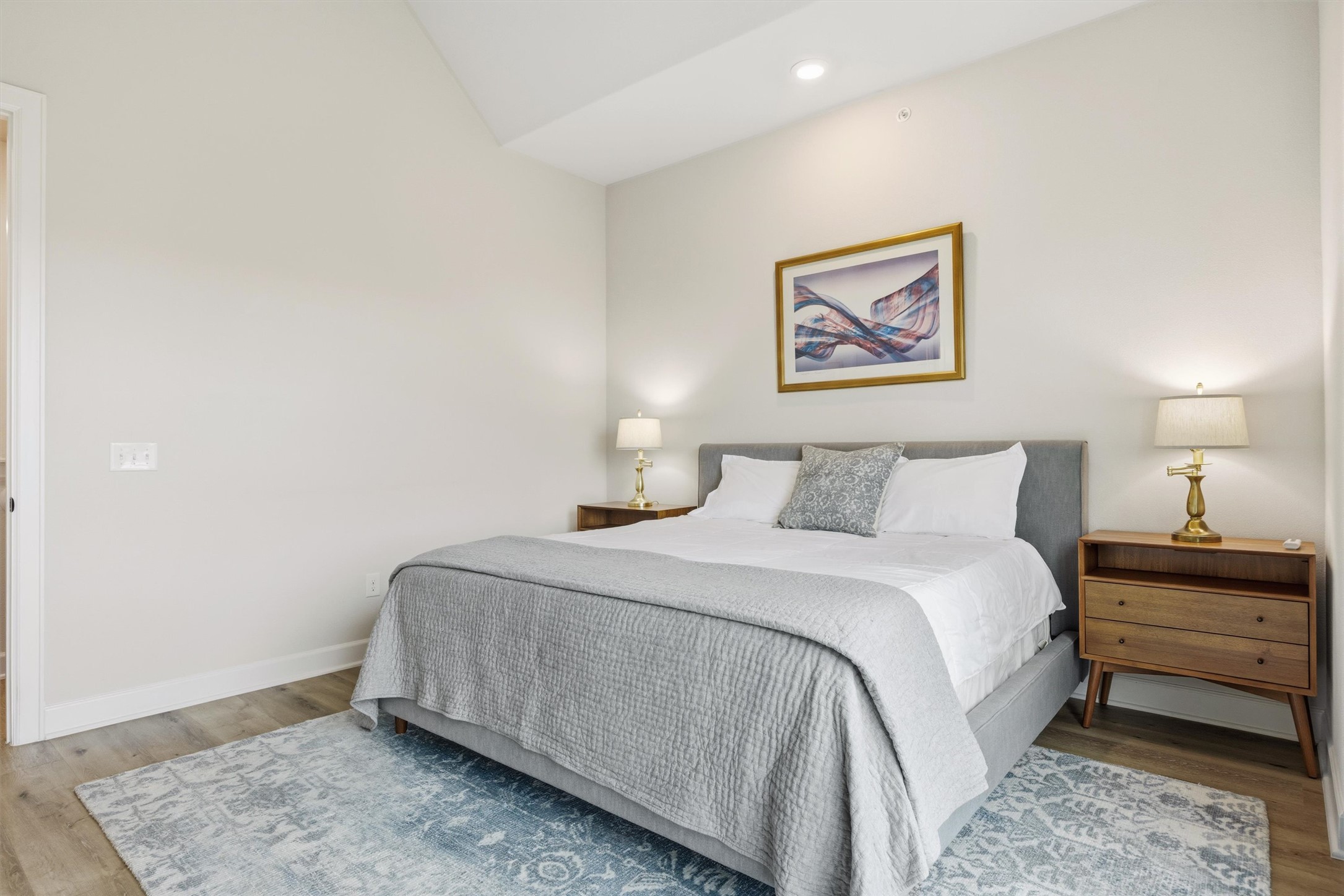 4704 Eberly Street Austin, TX 78723 - Photo 19 of 39 a bedroom with a bed and a night stand