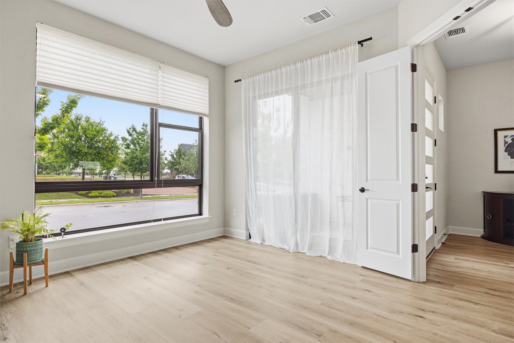 4704 Eberly Street Austin, TX 78723 - Photo 6 of 39 a view of an empty room with a window and hardwood floor