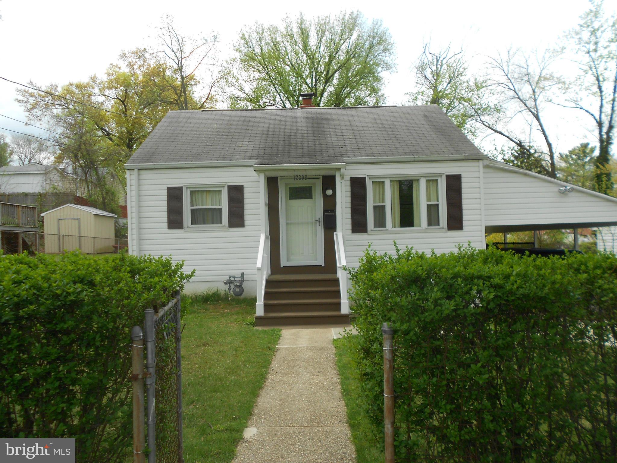 12308 Veirs Mill Road Silver Spring, MD 20906 - Photo 1 of 25 a front view of a house with a yard