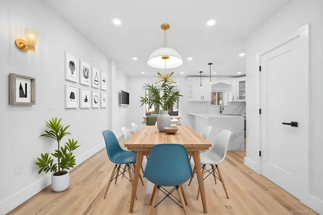 a dining room with furniture potted plants and wooden floor