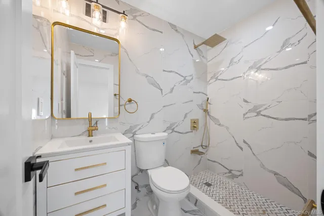 a bathroom with a sink a toilet and a mirror