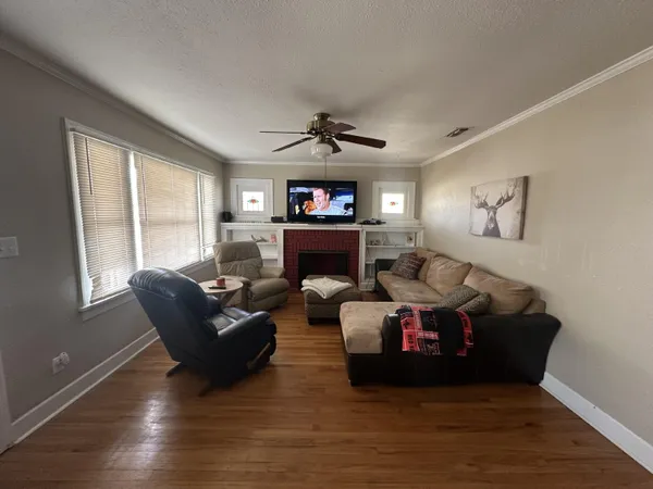 a living room with furniture and a fireplace