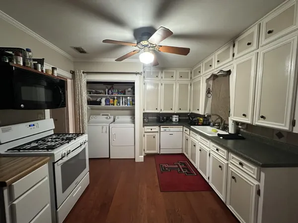 a kitchen with stainless steel appliances a sink stove and refrigerator