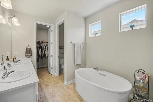 a bathroom with a sink mirror toilet and bathtub