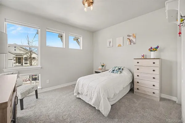 a bedroom with a bed and a dresser