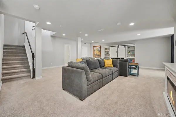a living room with furniture and a ceiling fan