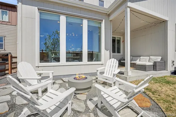 a view of a patio with couple of chairs and couches with wooden floor