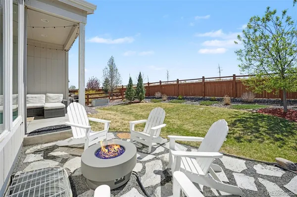 a view of a chairs and table in patio