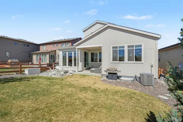 a view of a house with swimming pool and sitting area