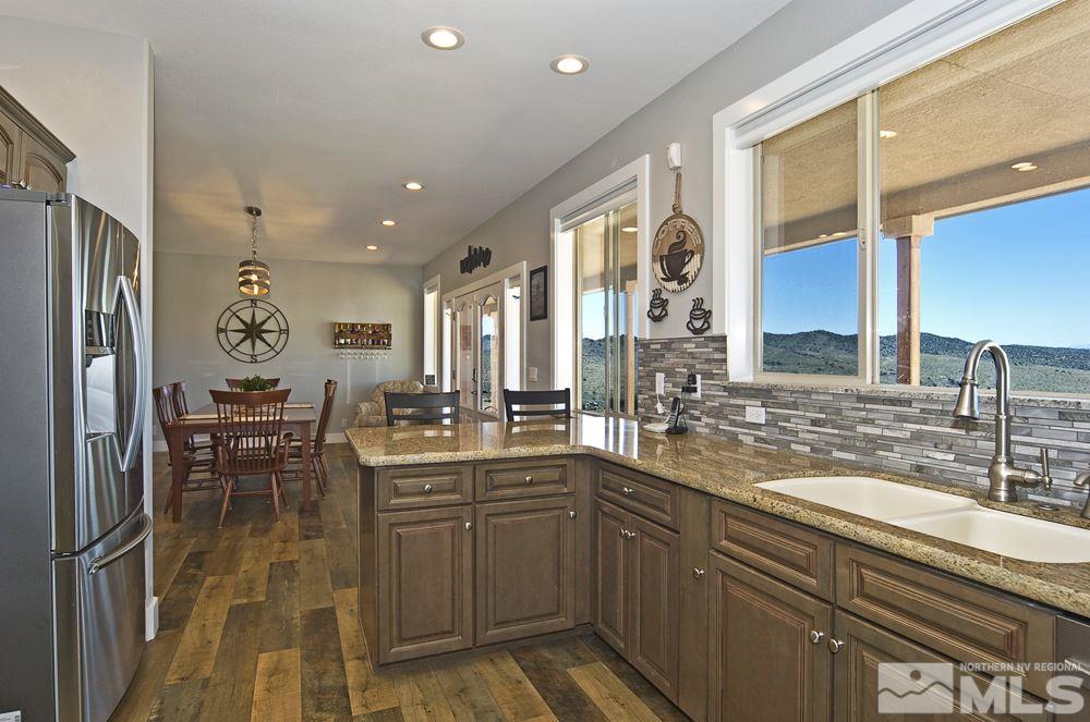 1375 Freds Mountain Road Reno, NV 89508 - Photo 11 of 40 a kitchen with lots of counter top space and dining table