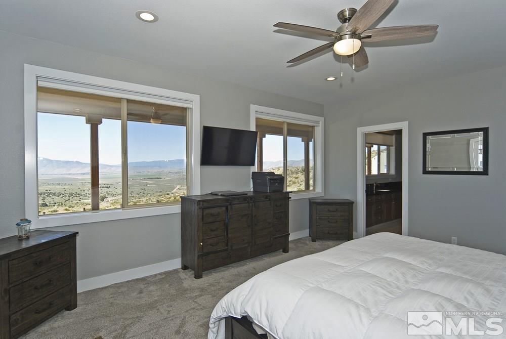 1375 Freds Mountain Road Reno, NV 89508 - Photo 14 of 40 a bedroom with a large bed and a large window