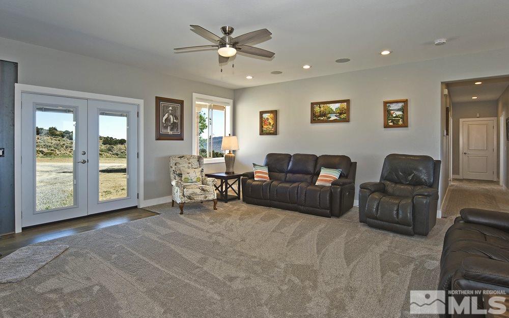 1375 Freds Mountain Road Reno, NV 89508 - Photo 23 of 40 a living room with furniture and three windows
