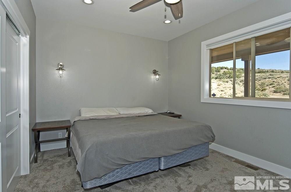 1375 Freds Mountain Road Reno, NV 89508 - Photo 29 of 40 a bedroom with a bed and a window