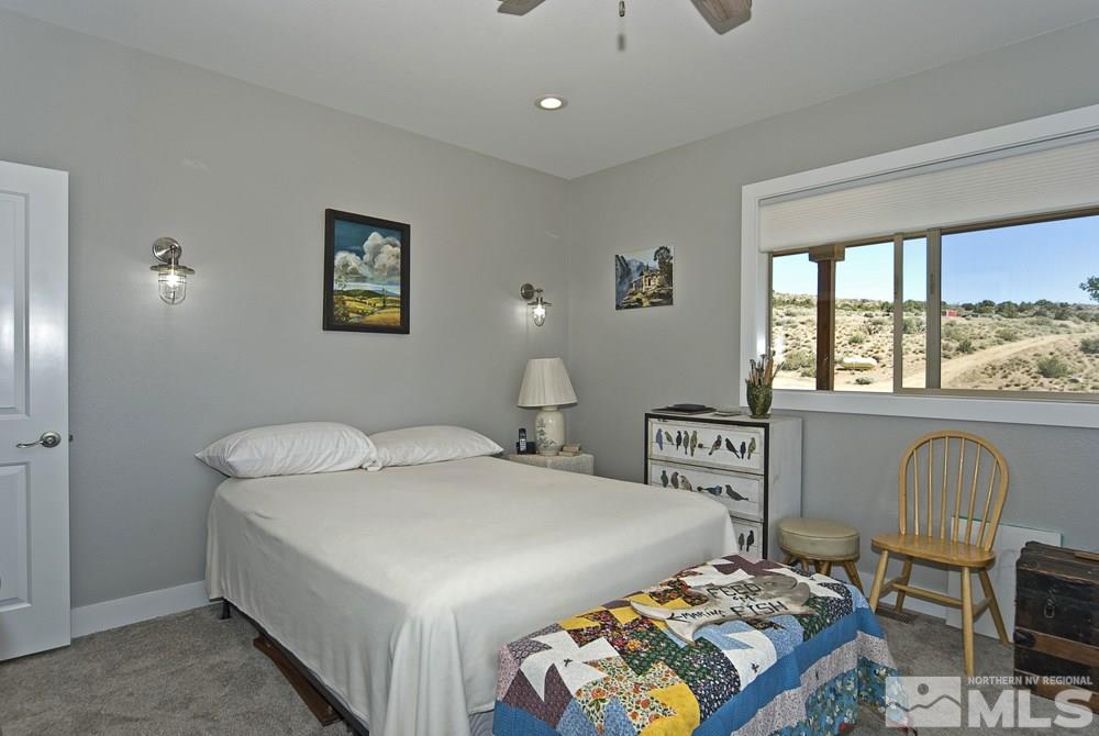 1375 Freds Mountain Road Reno, NV 89508 - Photo 30 of 40 a bedroom with a bed and a table in it