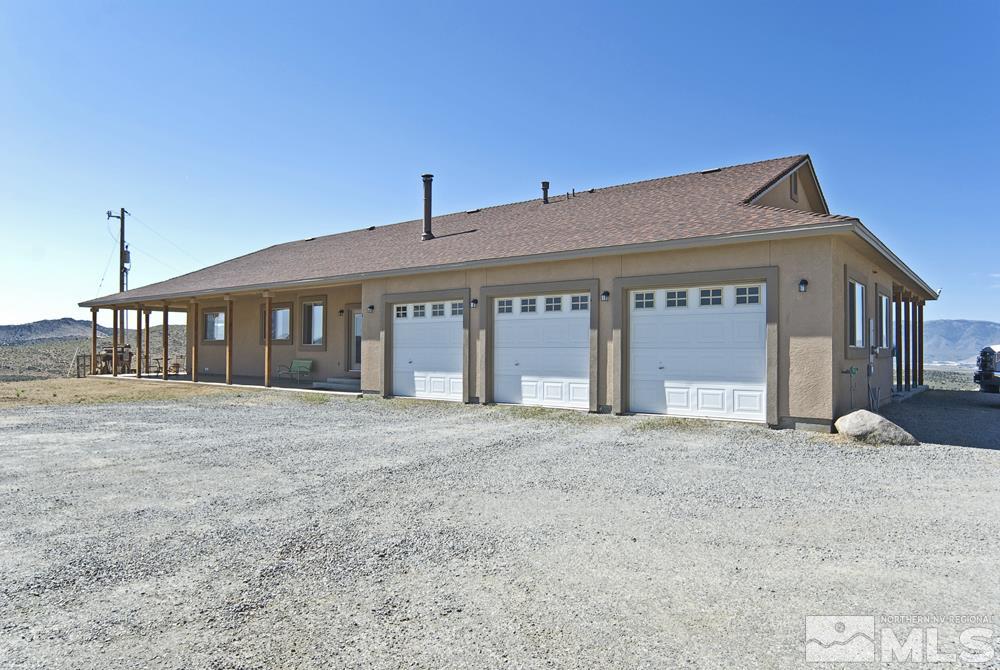 1375 Freds Mountain Road Reno, NV 89508 - Photo 3 of 40 a front view of a house with a yard