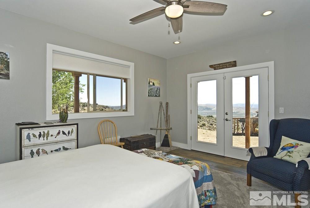 1375 Freds Mountain Road Reno, NV 89508 - Photo 31 of 40 a bedroom with a bed and a chandelier