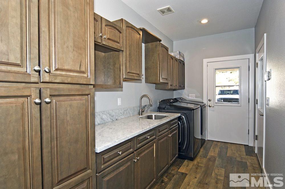 1375 Freds Mountain Road Reno, NV 89508 - Photo 7 of 40 a kitchen with stainless steel appliances granite countertop a refrigerator and a sink
