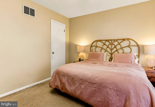 a bedroom with a bed and a wall painting