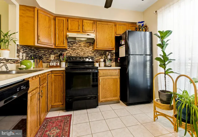 a kitchen with a refrigerator and a sink