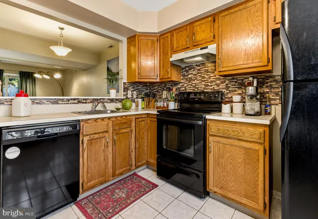 a kitchen with a sink stove and refrigerator