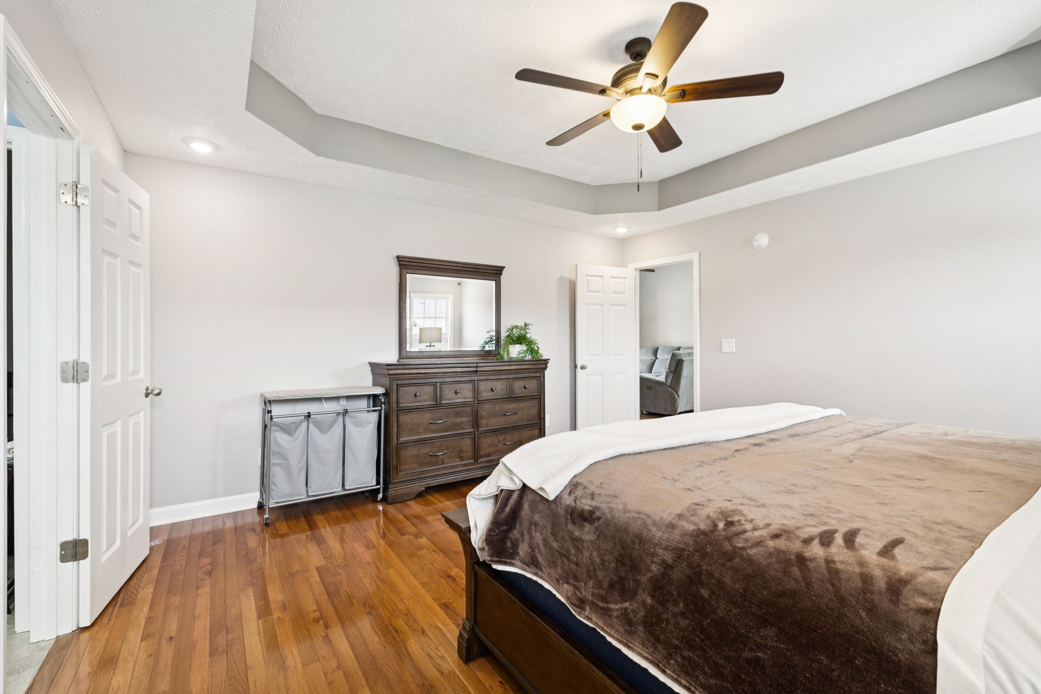 526 Stetson Court Murfreesboro, TN 37128 - Photo 9 of 26 a bedroom with a bed dresser and a wooden floor