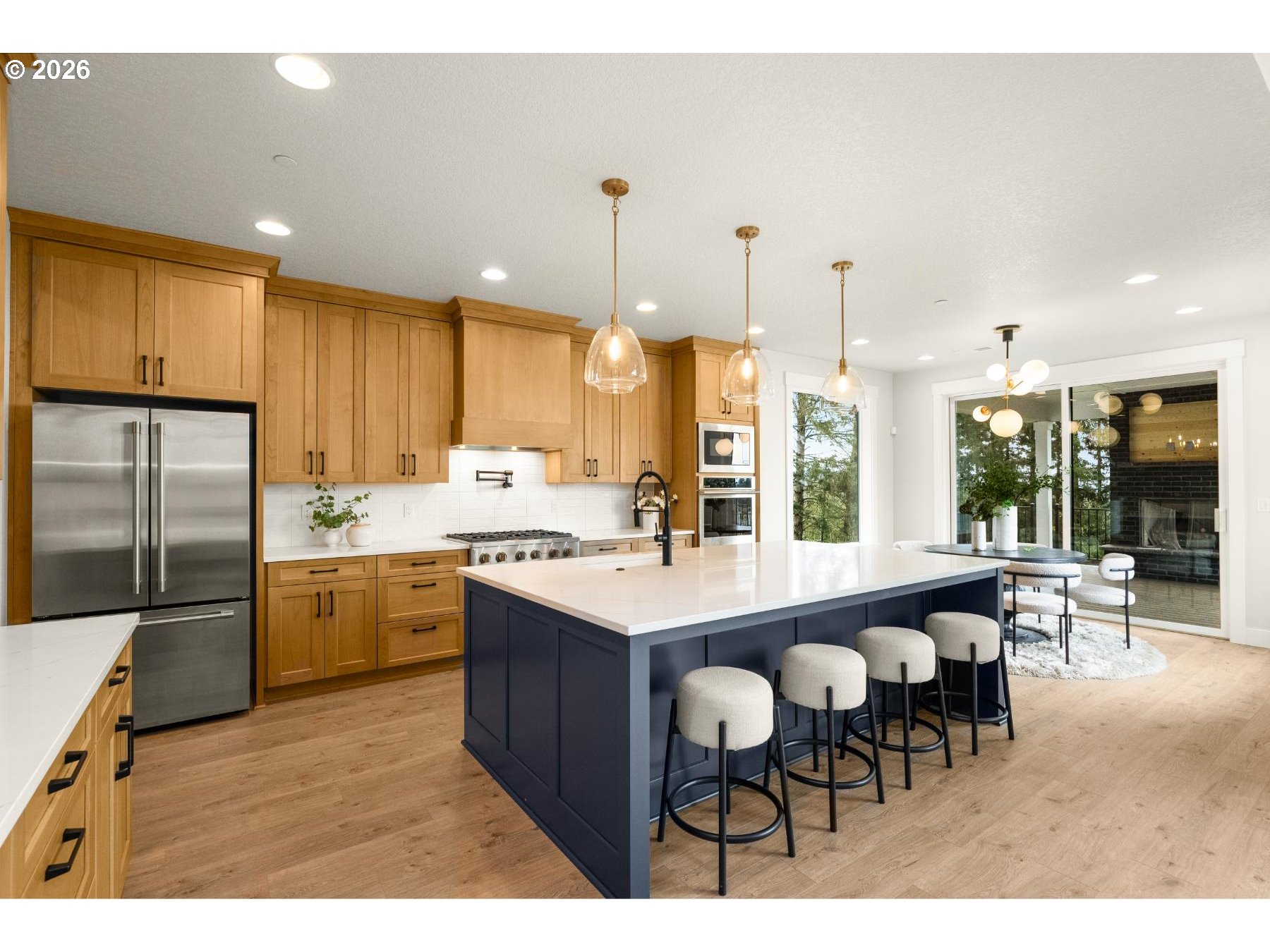 28410 Northeast Bell Road Newberg, OR 97132 - Photo 7 of 27 a kitchen with kitchen island granite countertop a table chairs sink and cabinets