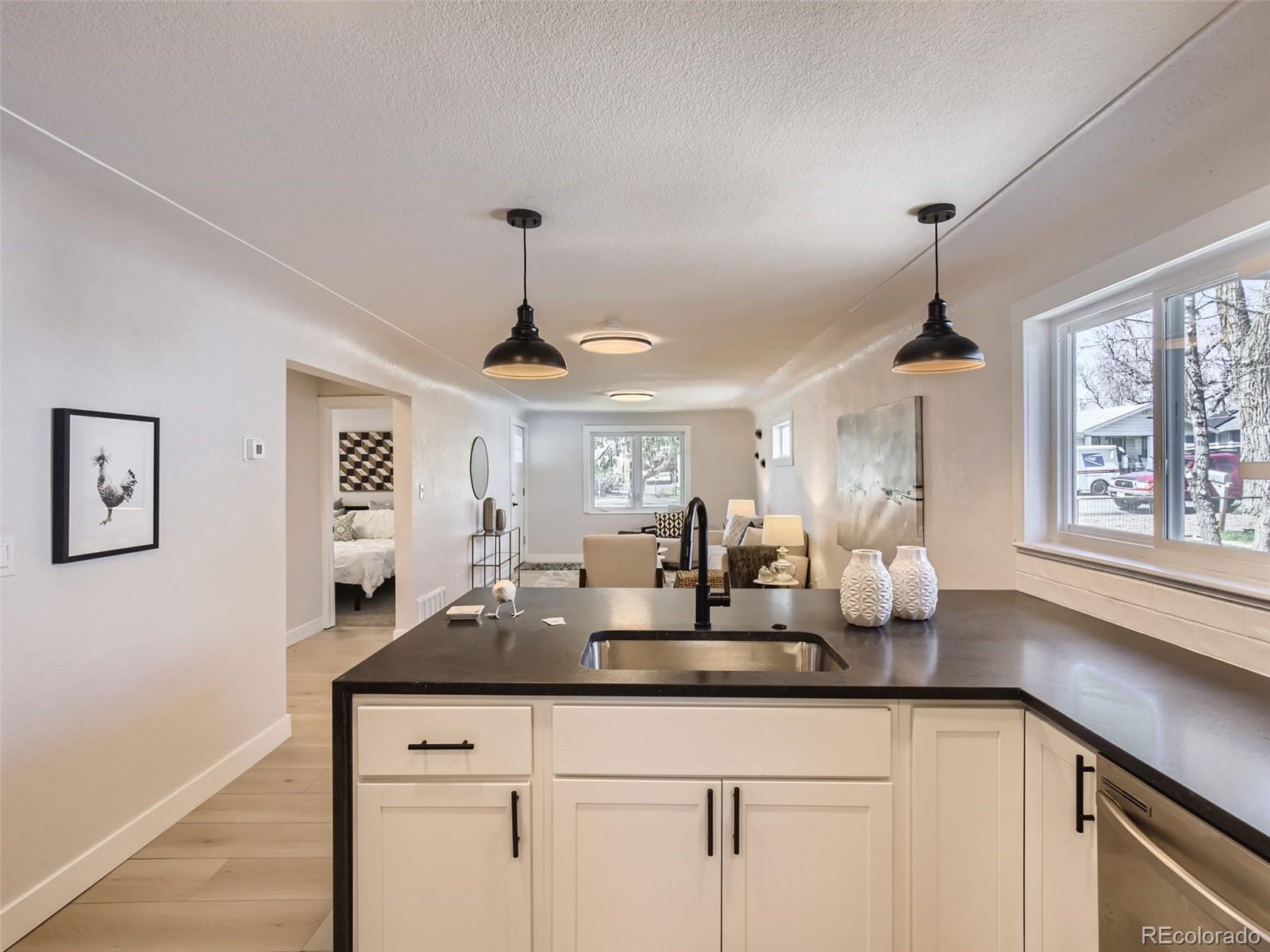 2814 Chase Street Wheat Ridge, CO 80214 - Photo 12 of 28 a kitchen with a counter space a sink and a window
