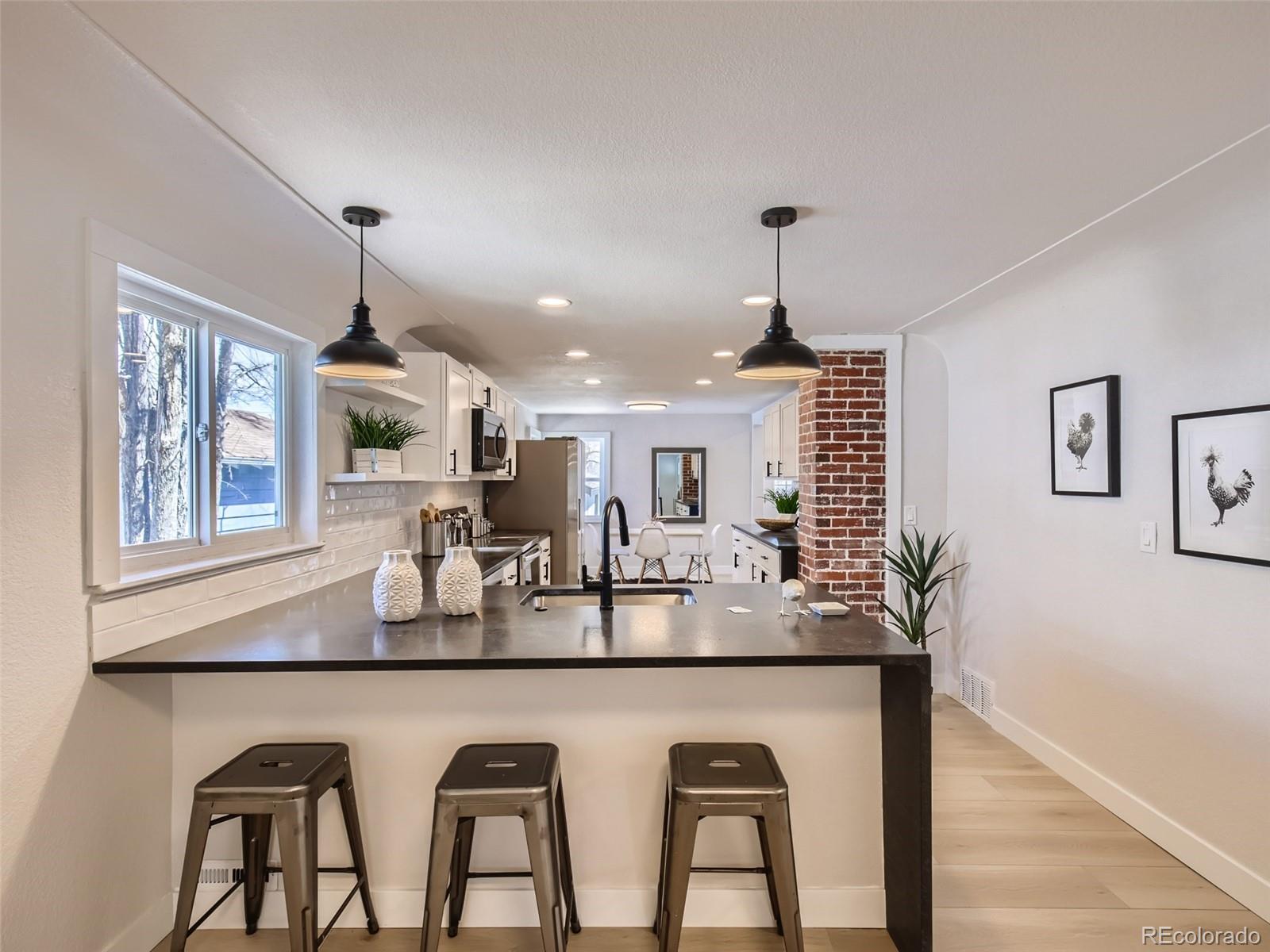 2814 Chase Street Wheat Ridge, CO 80214 - Photo 15 of 28 a dining hall with stainless steel appliances granite countertop furniture a window and kitchen view