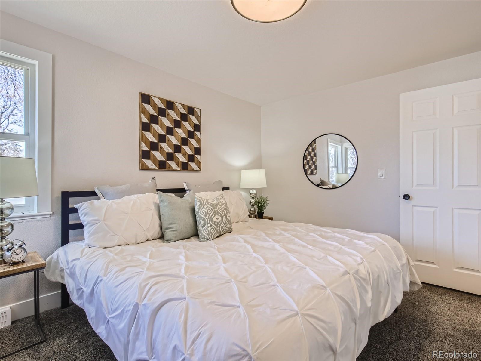 2814 Chase Street Wheat Ridge, CO 80214 - Photo 17 of 28 a bedroom with a bed and a window