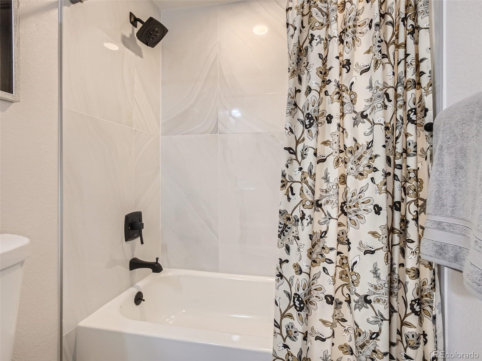 2814 Chase Street Wheat Ridge, CO 80214 - Photo 20 of 28 a bathroom with a bathtub and a shower