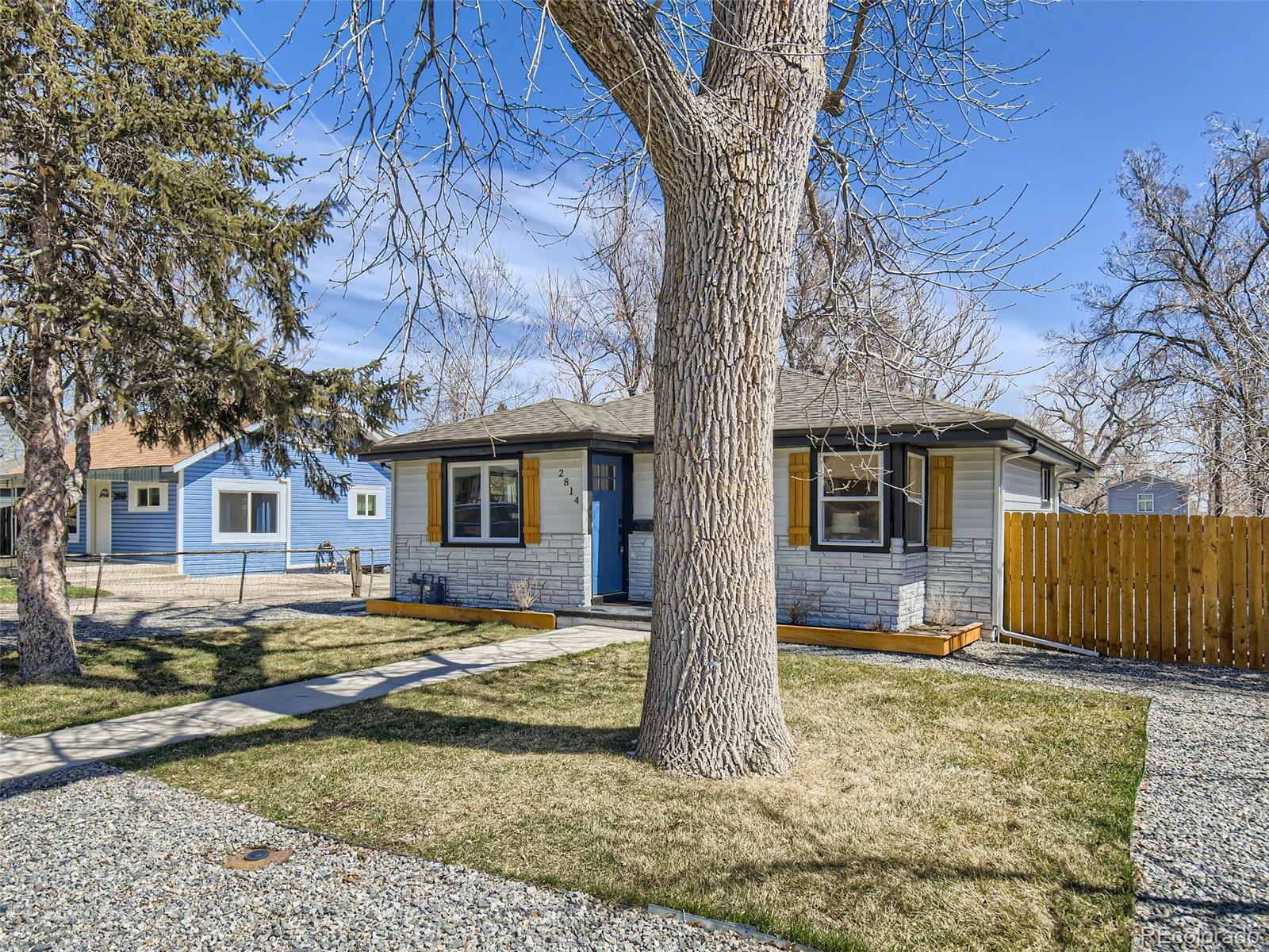 2814 Chase Street Wheat Ridge, CO 80214 - Photo 2 of 28 a view of a yard in front of a house with large tree