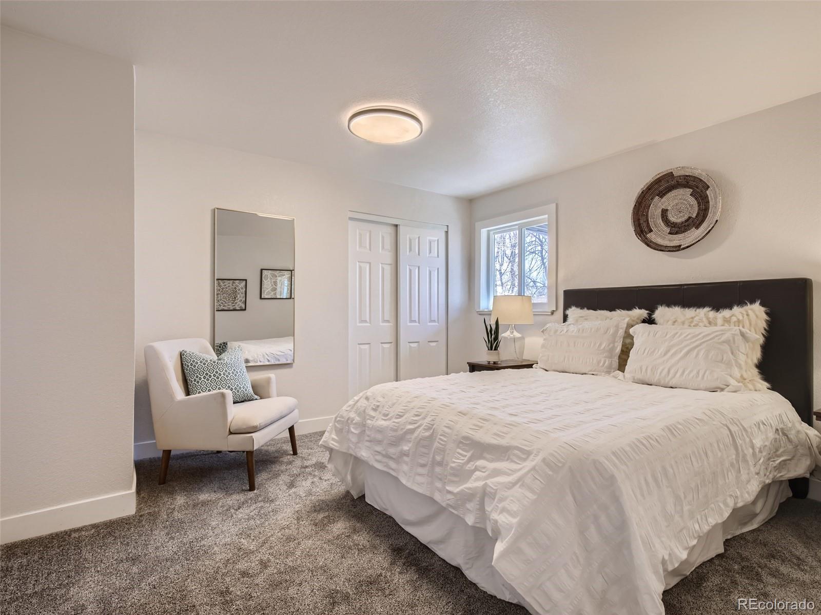 2814 Chase Street Wheat Ridge, CO 80214 - Photo 21 of 28 a bedroom with a bed and a couch