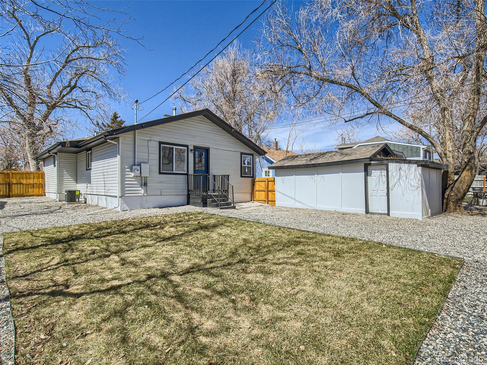 2814 Chase Street Wheat Ridge, CO 80214 - Photo 26 of 28 a view of a house with a yard