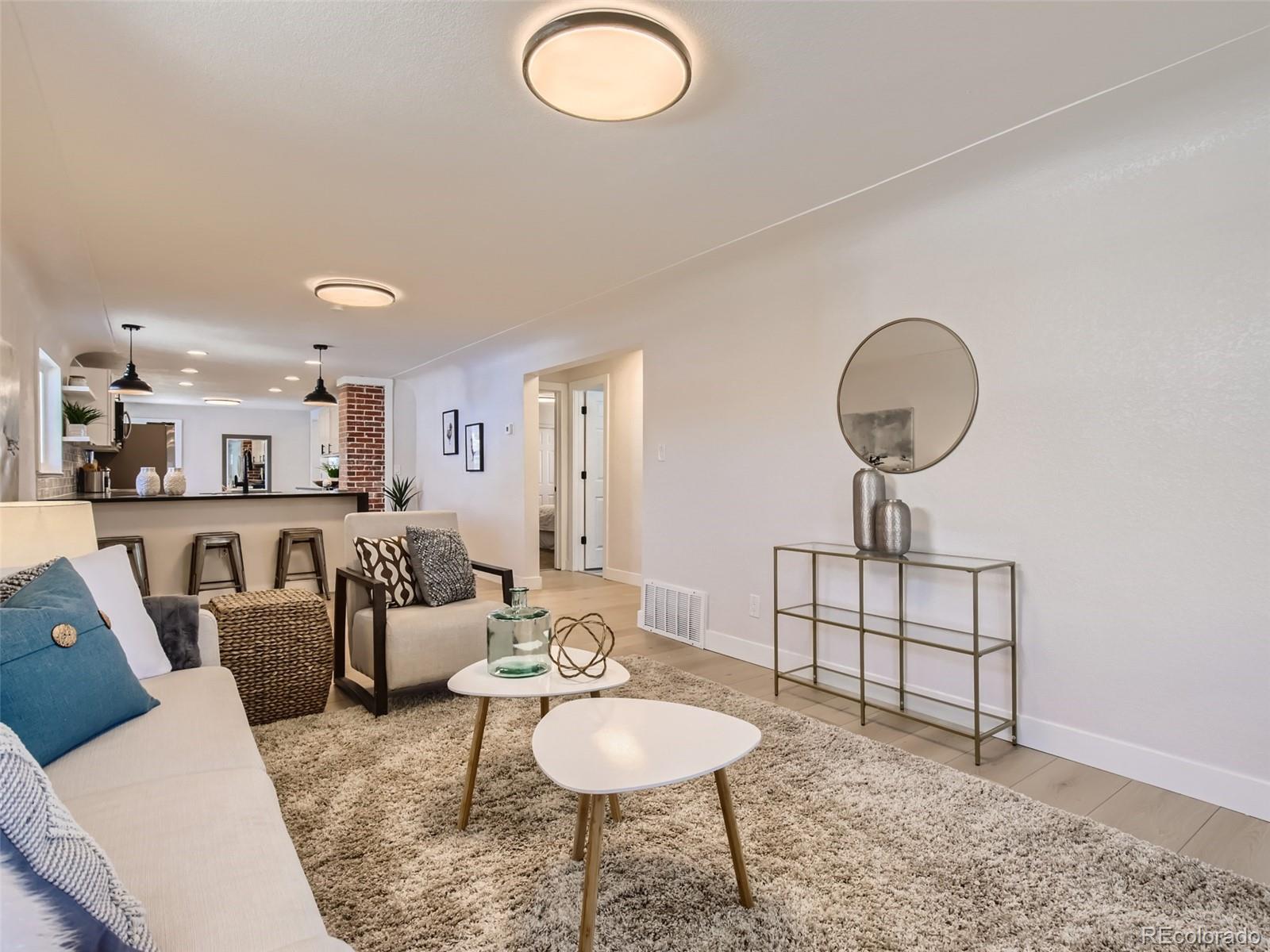 2814 Chase Street Wheat Ridge, CO 80214 - Photo 6 of 28 a living room with furniture and a wooden floor