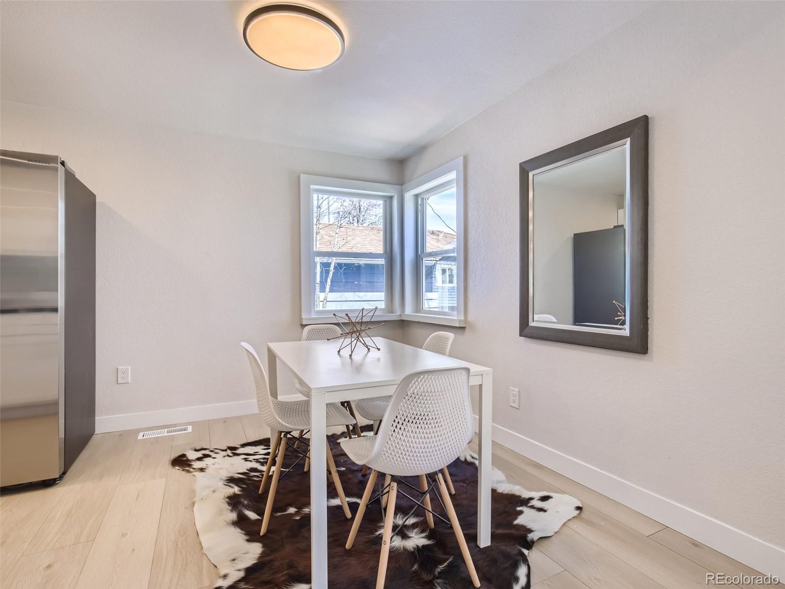 2814 Chase Street Wheat Ridge, CO 80214 - Photo 8 of 28 a view of a dining room with furniture and a window