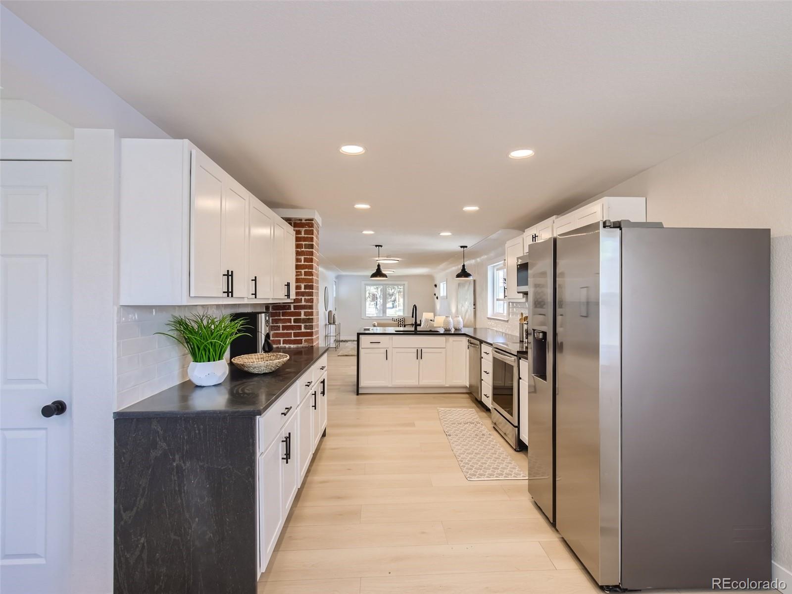 2814 Chase Street Wheat Ridge, CO 80214 - Photo 9 of 28 a kitchen with a sink and white stainless steel appliances